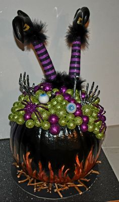 a halloween decoration made to look like a witch's hat with purple and green decorations