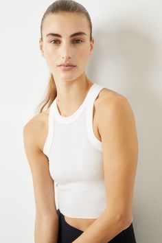 Ultra-soft and stretchy ribbed jersey High neckline Wide ribbed trim Raw hemline Signature graphic Pairs well with Rivington Ribbed Bra 96% Tencel, 4% Spandex Featured in Workout to Wherever How To Fold Sleeves, Cotton Citizen, Solid & Striped, Heather White, Bra Shop, Sustainable Clothing, White Tank Top, White Tank, Arm Candy