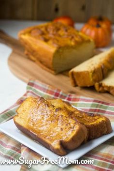 two slices of bread on a plate next to some pumpkins and other food items