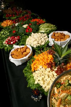 a buffet table filled with lots of different types of salads and other food items