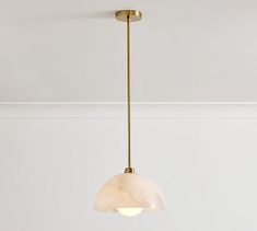 a light fixture hanging from the ceiling in a room with white walls and flooring