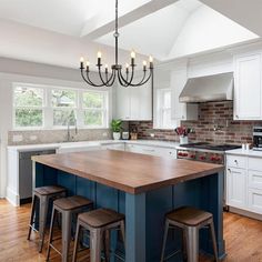 a large kitchen with an island in the middle