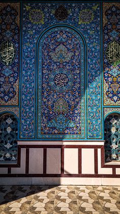 an intricately decorated wall in the middle of a building with arabic writing on it