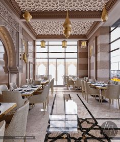 the interior of a restaurant with tables, chairs and chandeliers hanging from the ceiling