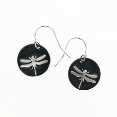 two dragonflys on a black disc earrings