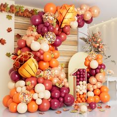 an arrangement of balloons and decorations for a fall themed party