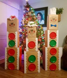 there are many boxes that look like traffic lights in front of a christmas tree with presents on it