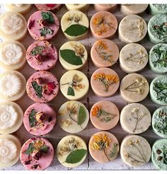 several different types of soaps with flowers and leaves on them are arranged in rows