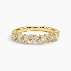 a yellow gold ring with five pear shaped diamonds