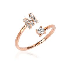 a rose gold ring with the letter f on it's side and diamonds in the middle