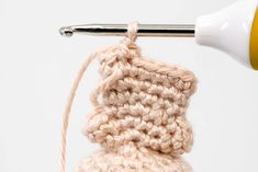 a crocheted object being worked on with a needle