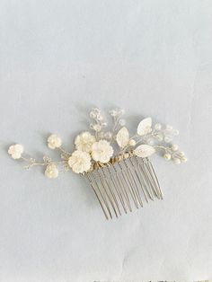 Mother of Pearl Hair Comb I made this hair comb using mother of pearl flowers, glass beads and silver metal leaves. Wired using silver tone wire. The hair comb looks elegant and is delicate, if you like to wear something simple yet classy.  Listing for 1 hair comb. Size - 3.5 inches end to end almost. Ready to ship!  Questions? Please send me a message. Ship Questions, Pearls Hair, Silver Hair Comb, Pearl Flowers, Pearl Hair Combs, Hair Comb Bridal, Flower Hair Comb, Metal Leaves, Bridal Hair Comb