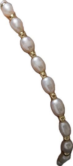 a white and gold bracelet with pearls on it