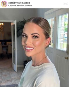 a woman is smiling for the camera in front of a house with tile flooring