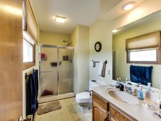 a bathroom with a sink, toilet and shower in it's own home area