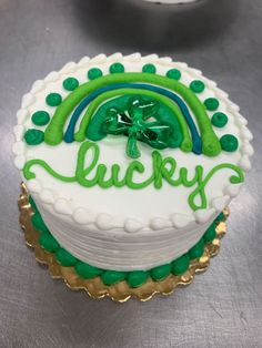 there is a cake that has been decorated with green and white icing on it