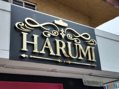 there is a sign that says harumi on the side of a storefront