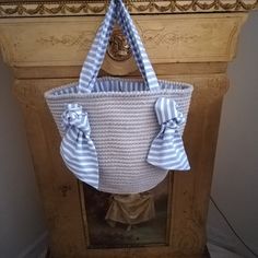 a blue and white striped bag hanging on a wall