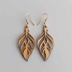 two pairs of wooden earrings with leaves on the front and back, one is made out of