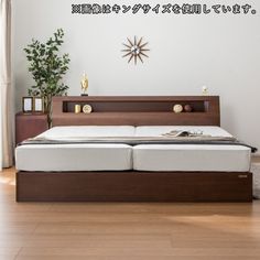 there is a bed that has been made with wood and white sheets in the room