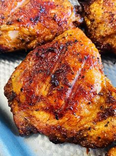 four pieces of meat sitting on top of a pan