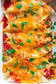 an enchilada dish with cheese, sauce and cilantro