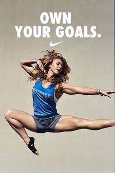 a woman is jumping in the air with her legs spread out and there is a nike advertisement behind her