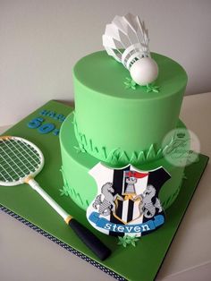 a green cake with a tennis racket and ball on top