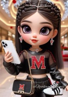 a doll is holding a cell phone and wearing a black outfit with the letter m on it