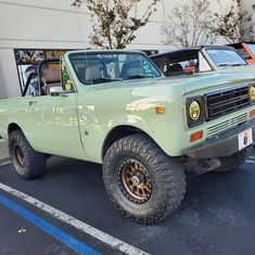 an old pick up truck parked in a parking lot