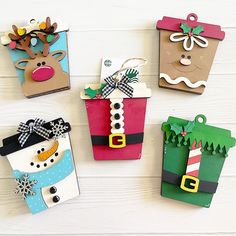 four christmas gift bags with paper decorations on them