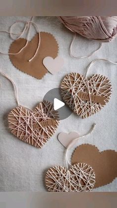 some paper hearts are hanging from string