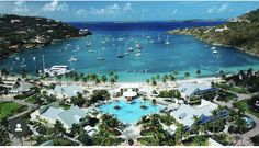 an aerial view of a resort with boats in the water