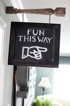 a sign that says fun this way hanging from the ceiling