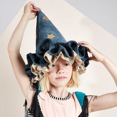 This witch's/wizard's hat, with ruffle details, is very stylish indeed. It is crafted from blue velvet, with gold lamé and gold glitter stars and moons. An essential accessory for Halloween, or to add to a dressing up box for imaginative play any time of the year. The hat is made from soft blue velvet It has ruffle details on the brim made from blue velvet and shiny gold lamé It has a blue velvet elastic strap with a hook and loop fastener Gold glitter stars and moons add a delightful embellishm Tocoto Vintage, Stars And Moons, Gold Glitter Stars, Ren Fest, 일본 패션, Authentic Models, Meri Meri, Glitter Stars, Blue Hat