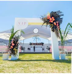 an outdoor wedding setup with flowers and greenery