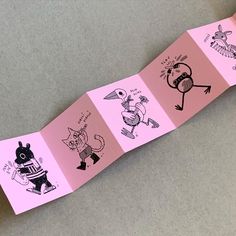 a pink paper strip with drawings on it