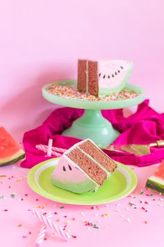 a slice of cake sitting on top of a plate next to watermelon slices