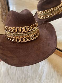 Our love of hats just got became a full-on obsession: meet the Beth Dutton Chain Banded cowboy hat! The most chic, high-end hat we could've ever dreamed up. A hat this good needs to be worn as much as possible and with every single outfit! Hand made by artisans, incredible quality, pure suede, hand placed chain around the crown, too many details to list! The best part? It's super structured with an elastic band on the inside that will fit EVERYONE. Btw never taking this hat off. These hats are a Beth Dutton, Suede Hat, Cowboy Style, Hat Band, Cowboy Hat, The Crown, Hat Fashion, Elastic Band, Leather Trims