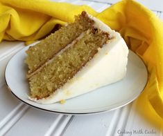 a slice of cake sitting on top of a white plate next to a yellow cloth