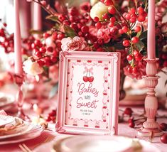 a baby are sweet sign sitting on top of a table with pink flowers and candles