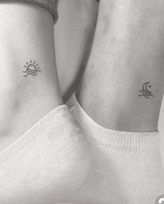 two small sun and moon tattoos on the wrist