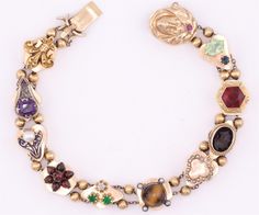 Lovely 14K yellow gold vintage slide bracelet with many different gemstones.  Diamond, ruby, seed pearl amethyst cameo, and more. 8 inches in length in the closed-clasped position.  16mm in width.  Slides are marked 14K  Guaranteed to please and ready to give. Heirloom Gold Multi-stone Bracelets, Heirloom Gold Bracelets With Multi-stone, Antique Multi-stone Bracelet For Formal Occasions, Antique Multi-stone Bracelets For Formal Occasions, Antique Gold Multi-stone Jewelry, Antique Multi-stone Formal Jewelry, Antique Multi-stone Gold Jewelry, Vintage Oval Multi-stone Bracelets, Heirloom Yellow Gold Multi-stone Bracelets