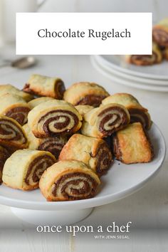 chocolate rugelach is on a plate with other desserts in the background and text overlay that reads, once upon a chef