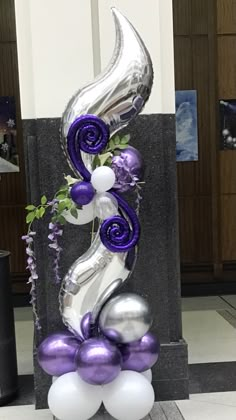 balloon sculpture with purple and silver decorations