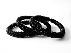 "This set of 3 no clasp, over wrist stretch bracelet bangles were beaded extra small with tiny black glass seed beads. The beads were woven over stretchy cords. Bracelet set is for your actual wrist size of 5\" inch circumference ( 12.7 cm ). The eased length of the bracelets are 7\" inches ( 17.78 cm ). More woven beaded stretch bracelets, link below. https://www.etsy.com/shop/FMGuyDesigns?ref=seller-platform-mcnav&section_id=27005693 https://www.etsy.com/shop/FMGuyDesigns" Handmade Black Wristlet With Round Beads, Hand-strung Black Beaded Bangle Bracelet, Handmade Black Bead Bangle, Handmade Black Bangle Beads, Handmade Black Stretch Bangle Bracelet, Handmade Black Round Bangle, Wrist Stretches, Glass Bangles, Bangles Set