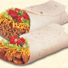 two burritos with meat, cheese and tomatoes on them sitting side by side