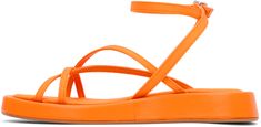 Canvas sandals in orange. · Open square toe · Criss-crossing straps at vamp · Wraparound pin-buckle ankle strap · Logo patch at canvas footbed · Leather-covered midsole · Rubber outsole Supplier color: Orange Orange Sandals With Ankle Strap And Heel Loop, Orange Single Toe Strap Sandals For Spring, Orange Square Toe Sandals For Spring, Spring Orange Square Toe Sandals, Orange Strappy Sandals With Heel Strap, Trendy Orange Slip-on Sandals, Orange Flat Non-slip Sandals, Orange Sandals With 4-inch Heel And Round Toe, Orange Open Toe Sandals With 4-inch Heel