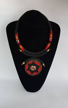 100% handcrafted using fine beads. The necklace makes a perfect gift. This necklace is approximately 17 inches long and 4 inches pendant. **Buy multiple items and pay shipping for 1 item only.The rest ships free. More neckleces here; https://www.etsy.com/shop/TribalTess?ref=seller-platform-mcnav&section_id=21306083 Back to my shop; https://www.etsy.com/shop/TribalTess?ref=seller-platform-mcnav Traditional Black Beaded Necklaces As Gift, Traditional Black Beaded Necklaces For Gift, Artisan Red Beaded Necklace With Black Beads, Traditional Beaded Necklace With Polished Round Pendant, Traditional Beaded Necklace With Round Pendant, Gift Pendant Beaded Necklaces With Large Beads, Traditional Handmade Medallion Necklace Gift, Traditional Handmade Round Medallion Necklace, Traditional Black Beaded Pendant Necklace