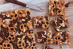 chocolate and pretzels are arranged on a cutting board